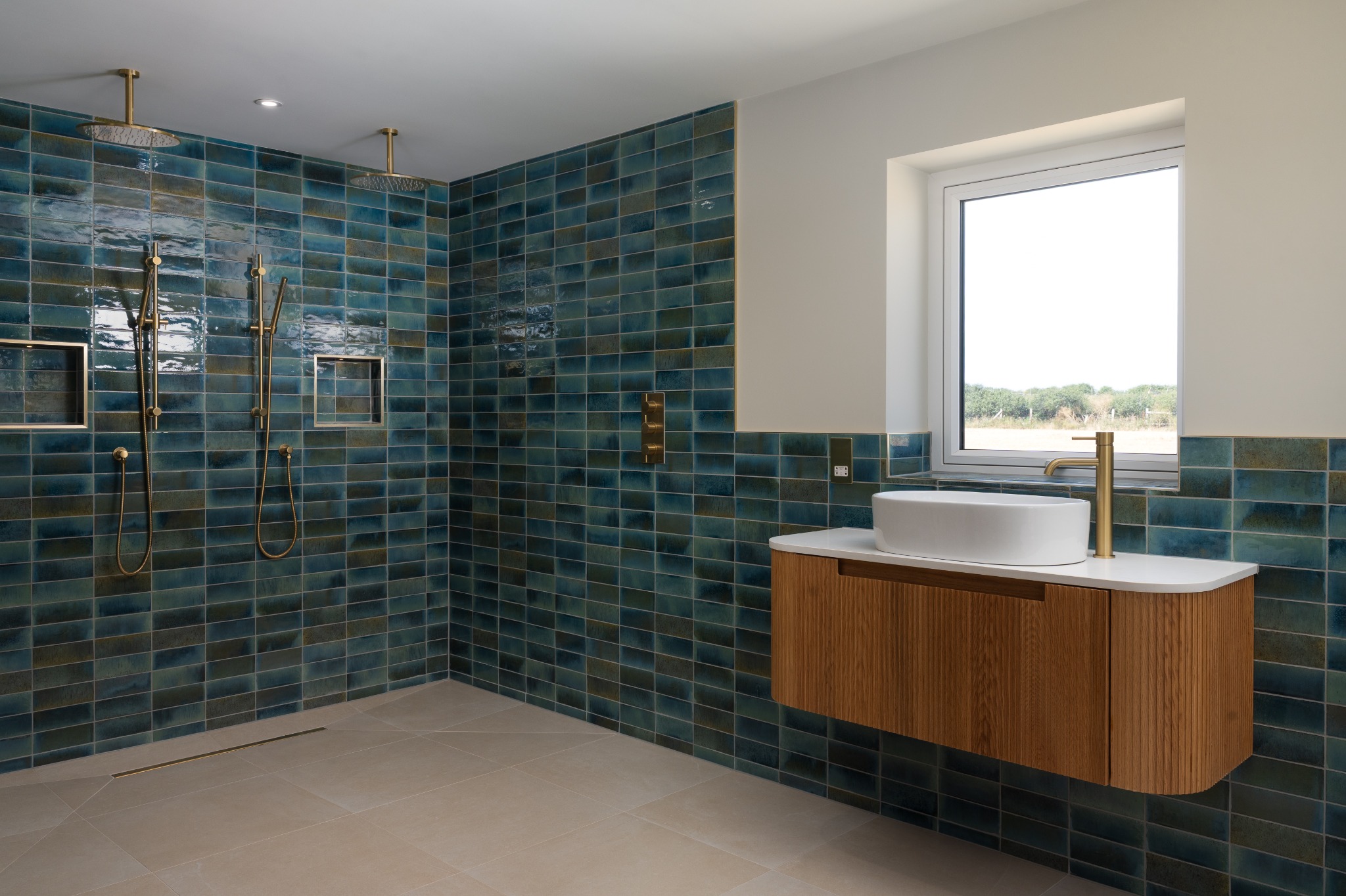 Blue-tiled shower room with oak vanity