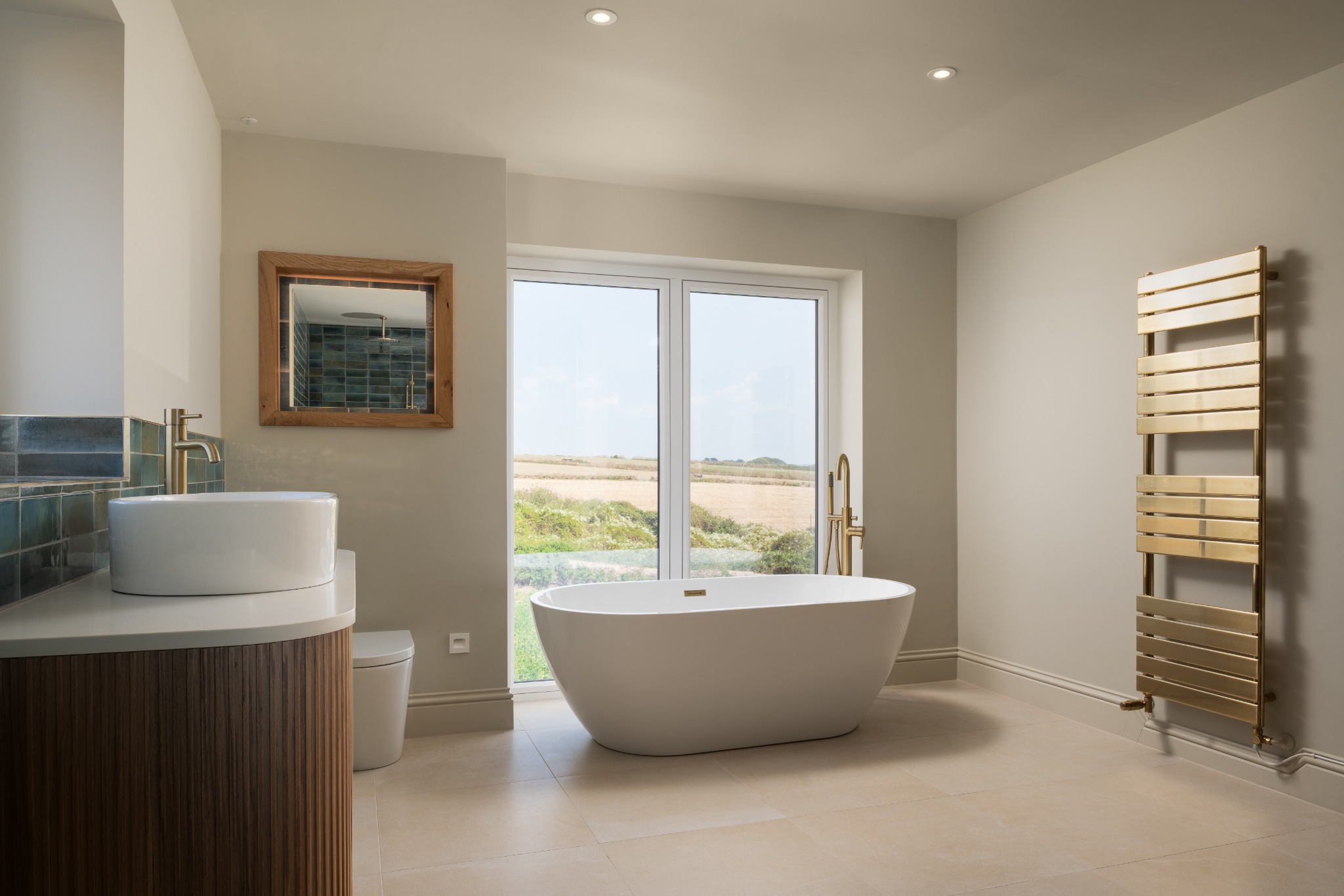 Bathroom with blue tile and freestanding bath