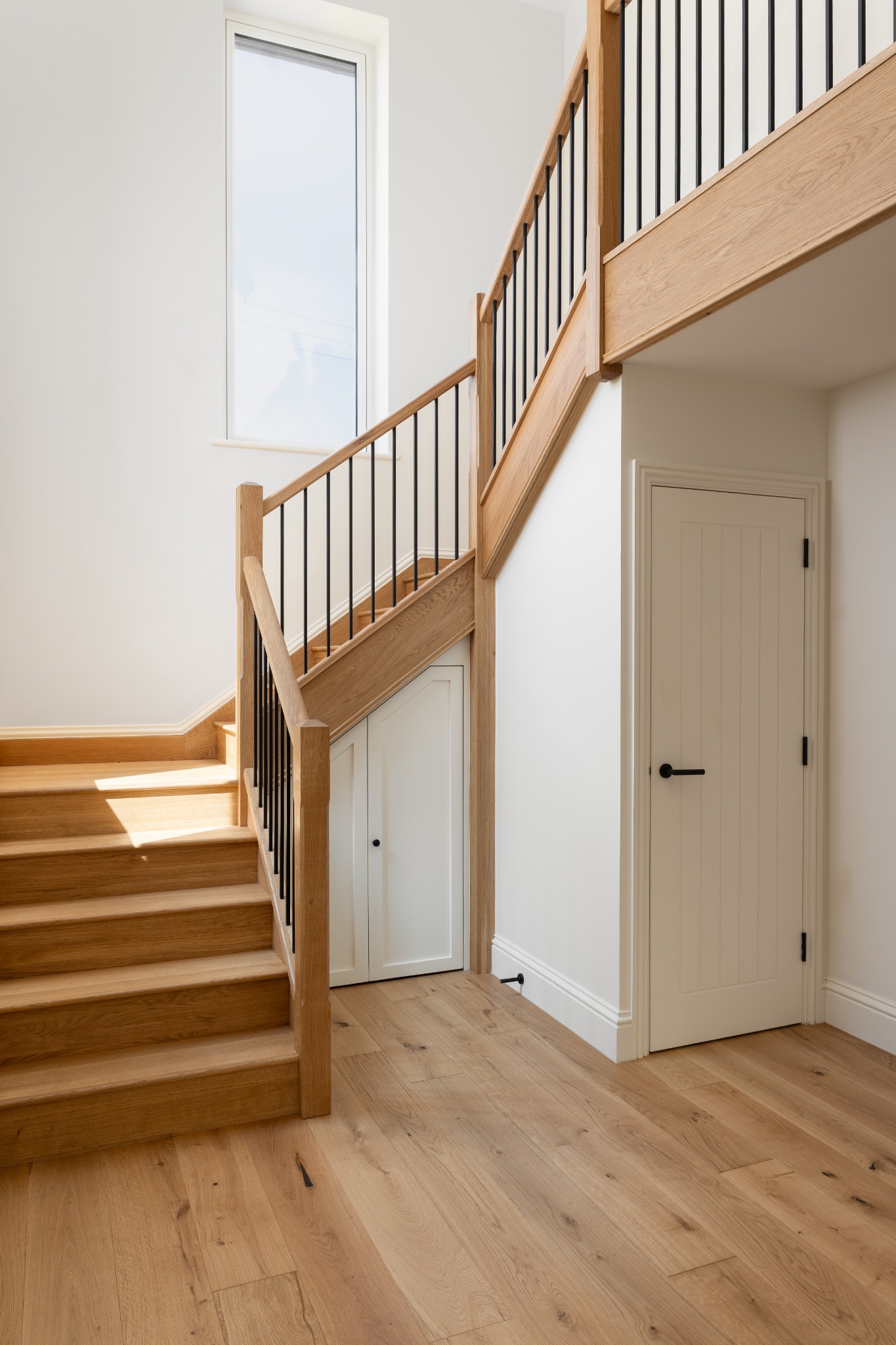 Oak staircase and tall stairwell window