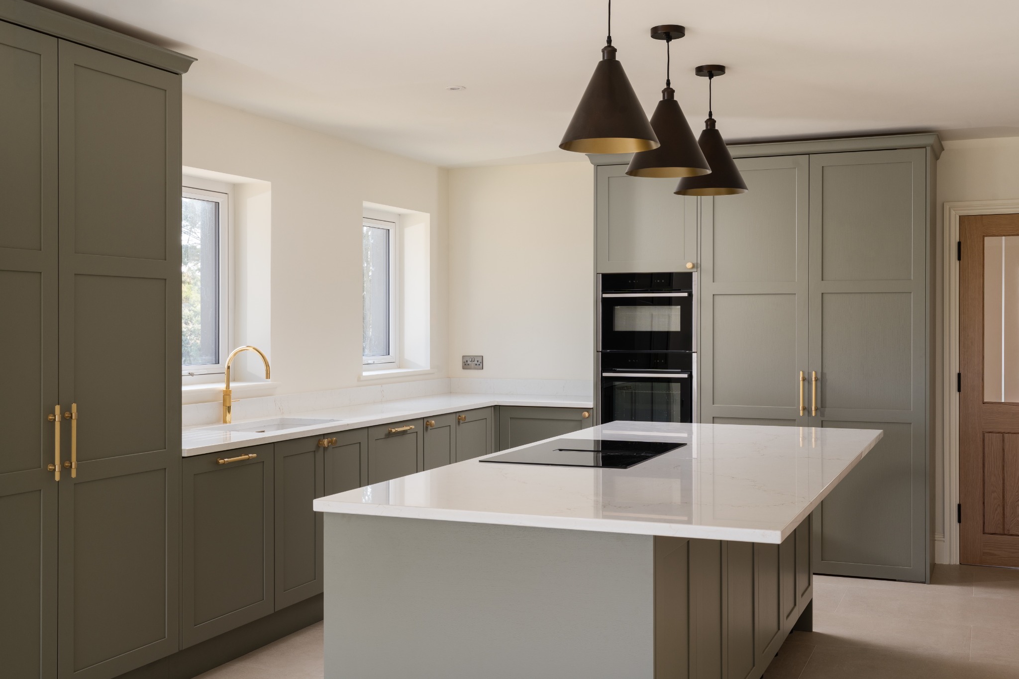 Green kitchen cabinetry and island