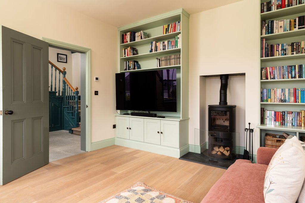 Living room with bespoke cabinetry and wood burner