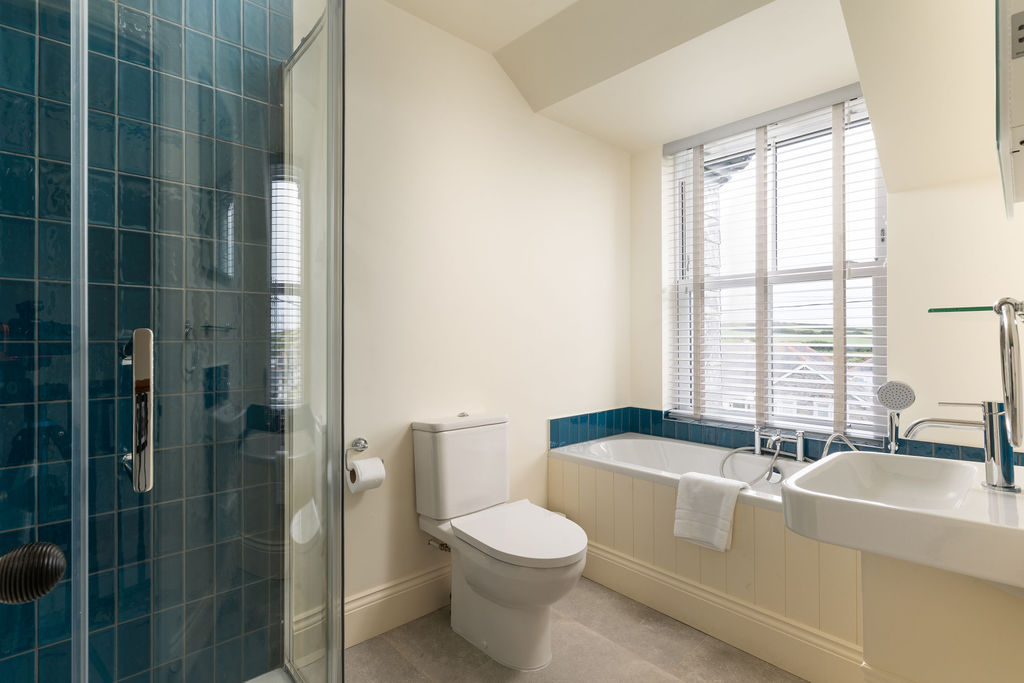 Bathroom with bath, shower and blue-green tile
