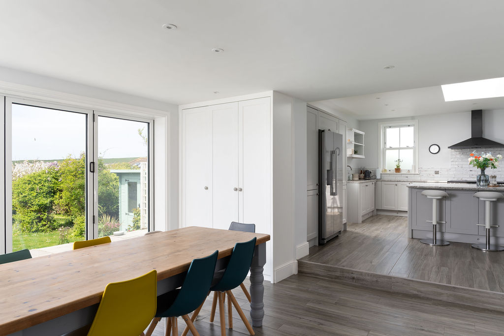 Dining area leading into the white kitchen